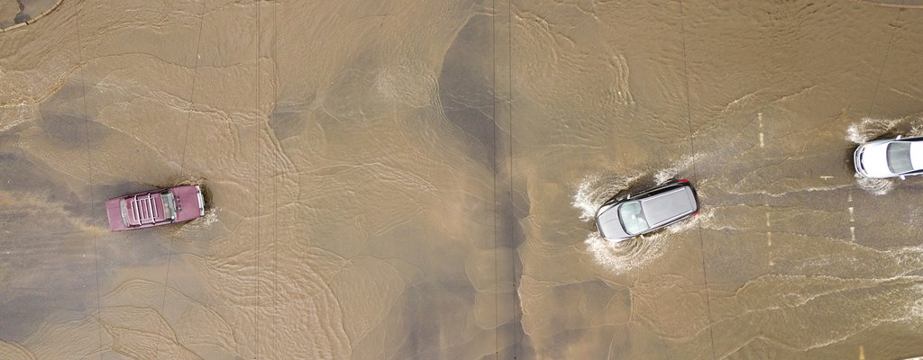 aerial-view-of-traffic-cars-driving-on-flooded-roa-2023-11-27-05-19-57-utc